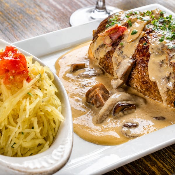 Savory meatloaf with mushroom gravy and a side of spaghetti squash topped with diced tomatoes.