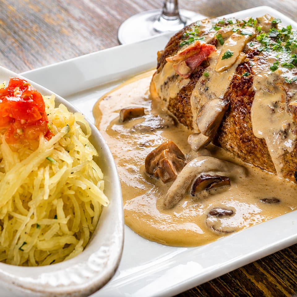 Savory meatloaf with mushroom gravy and a side of spaghetti squash topped with diced tomatoes.