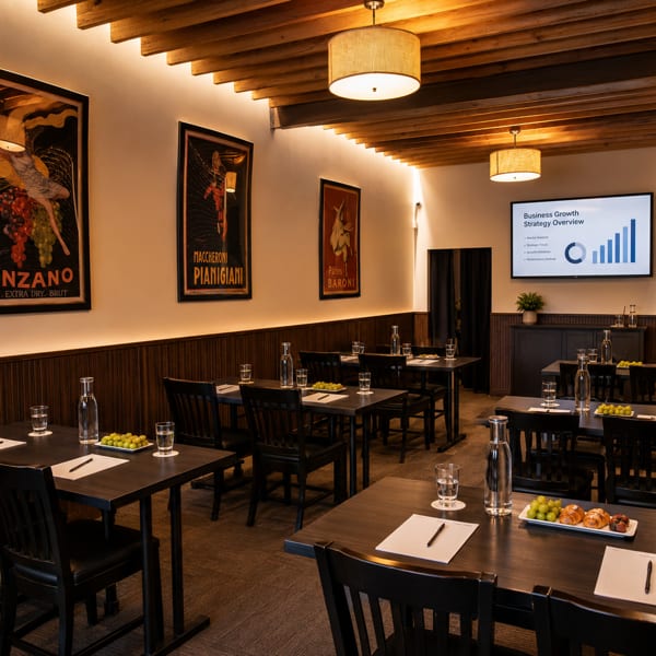 A meeting room with dark tables, chairs, vintage posters, and a screen displaying a business presentation.